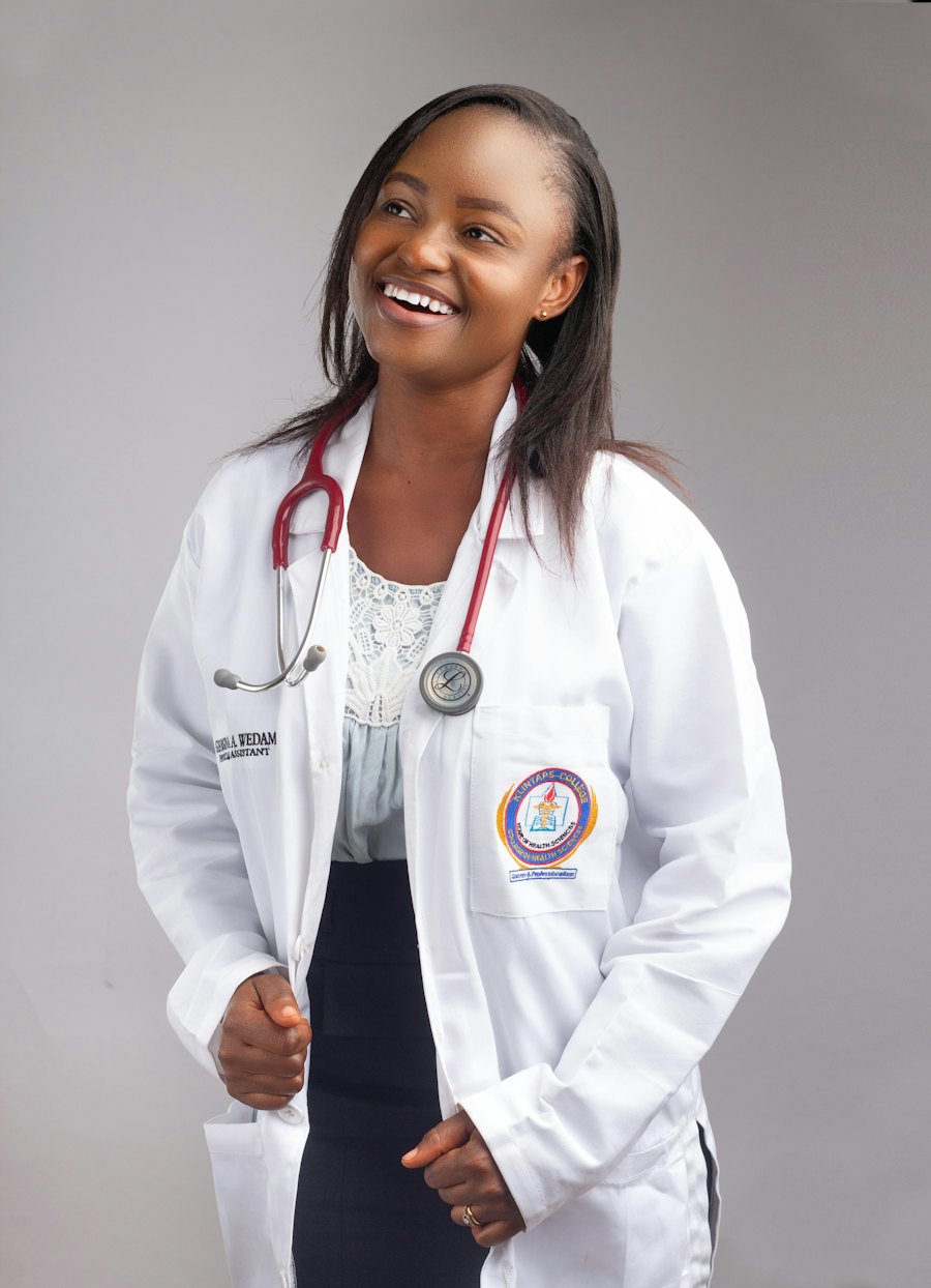 A smiling clinician in a white coat with a stethoscope around her neck
